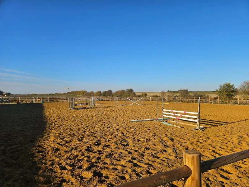 La carrière d’obstacle au soleil, barres et chandeliers montés, les plaines derrière